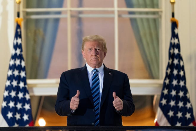 President Donald Trump gives thumbs up on the Blue Room Balcony upon returning to the White House Monday, Oct. 5, 2020, in Washington, after leaving Walter Reed National Military Medical Center, in Bethesda, Md. Trump announced he tested positive for COVID-19 on Oct. 2.