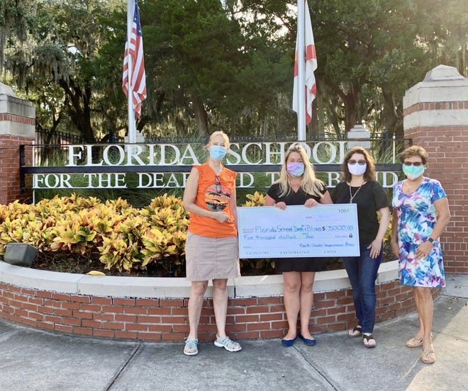From left, Jean Miller, Tanya Rhodes, Amy Gilbert and Fran Windeler stand in front of Florida School for the Deaf and the Blind.