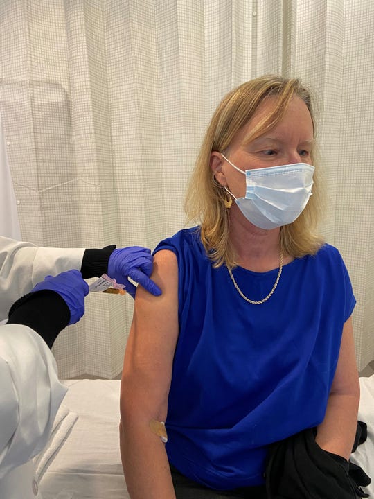 A participant in Moderna's clinical trial of a vaccine for COVID-19 receives an injection. Half of the participants received the  vaccine, and half received a placebo.