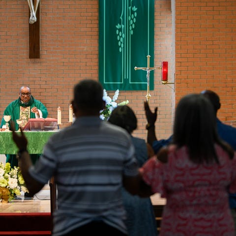 Parishioners stand in Our Lady of Grace Catholic C