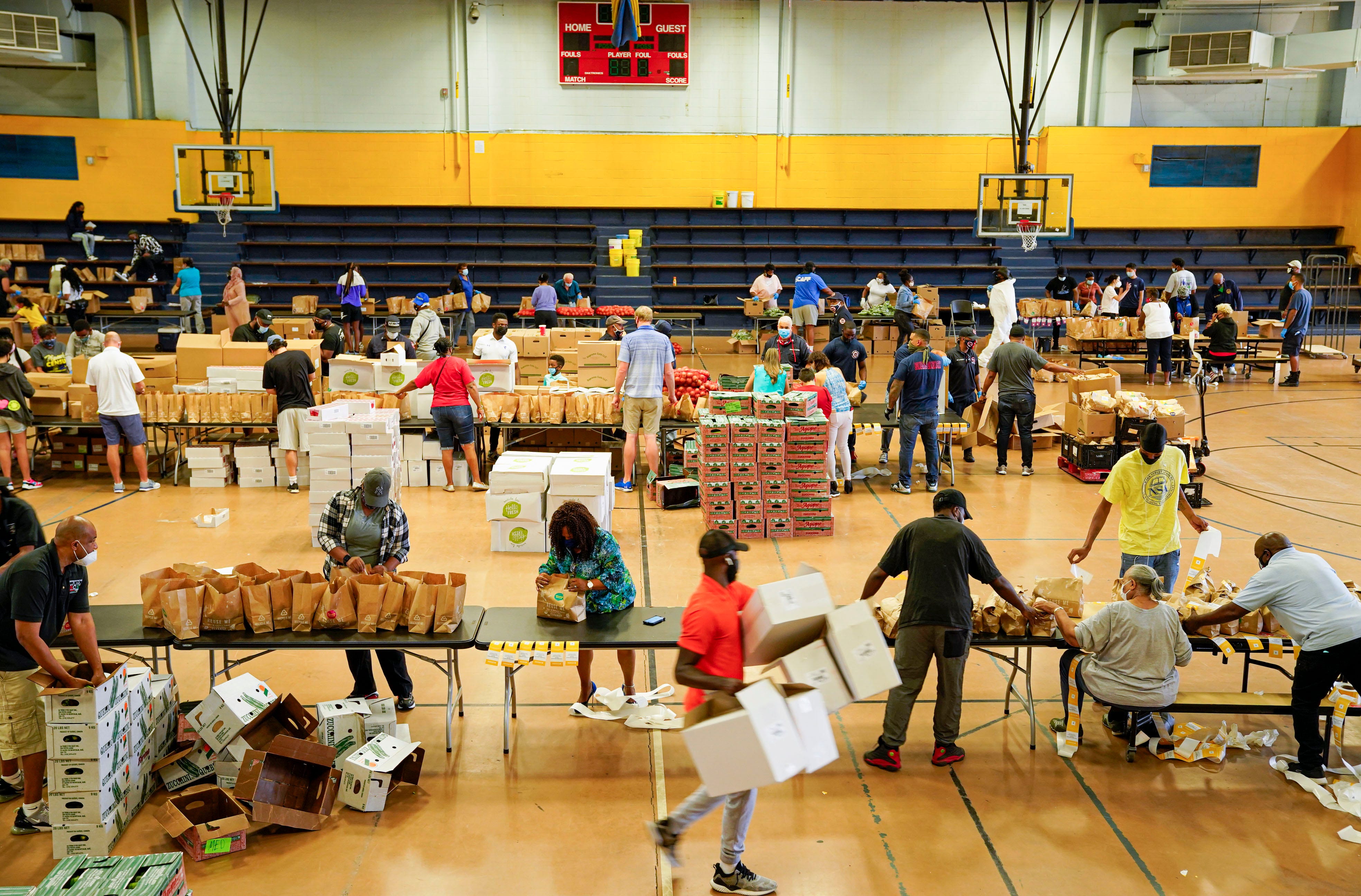 Volunteers, mostly city employees, help pack bags of food for families in need at the John F. Kennedy Recreation Center in Newark.