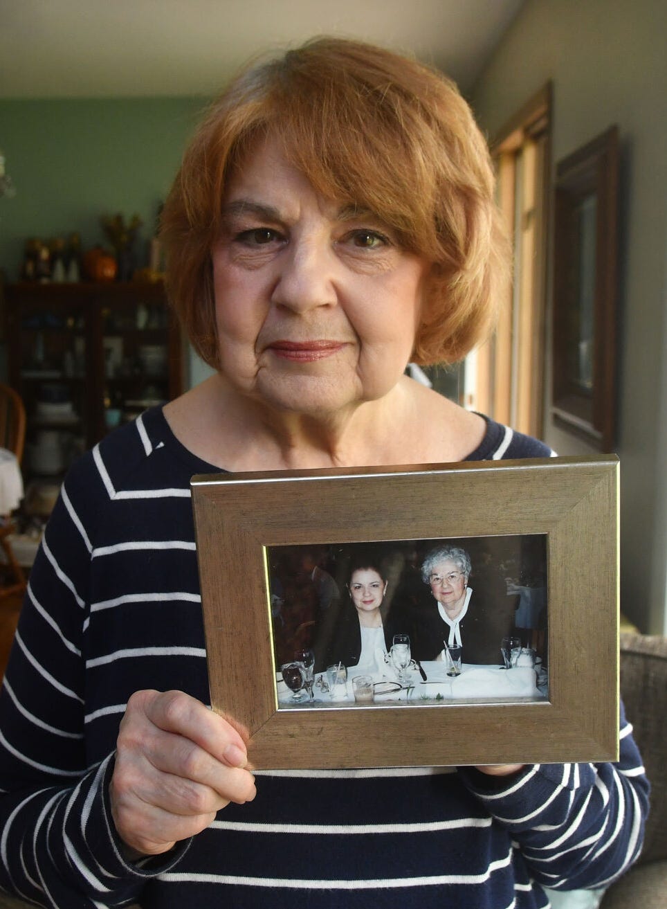 Linda Nordeen, of Davenport, holds a photo of her mother Mary Ann Otte, who died of COVID-19.