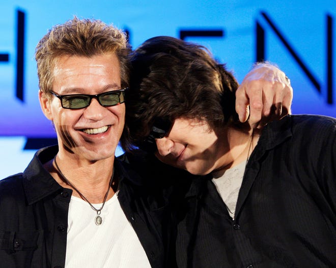 The late Eddie Van Halen, left, embraces his son Wolfgang Van Halen after the rock group Van Halen officially announced their North American tour during a news conference in Los Angeles on Aug. 13, 2007.