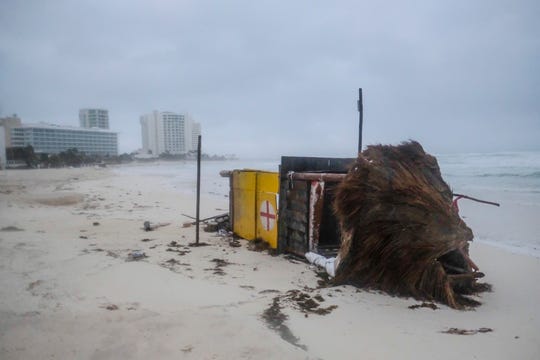A lifeguard tower lays on its side after it was toppled over by Hurricane Delta in Cancun, Mexico, early Wednesday.