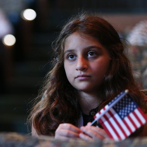 A young U.S. citizen, originally from Iran, holds 