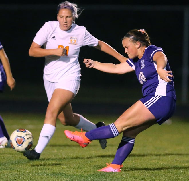 Jackson's Marysa Starcher (28) kicks the ball while Green's Delanie Hallock (21) defends during a game earlier this month. Starcher scored a goal for the Polar Bears in Wednesday's 6-0 win over Perry.