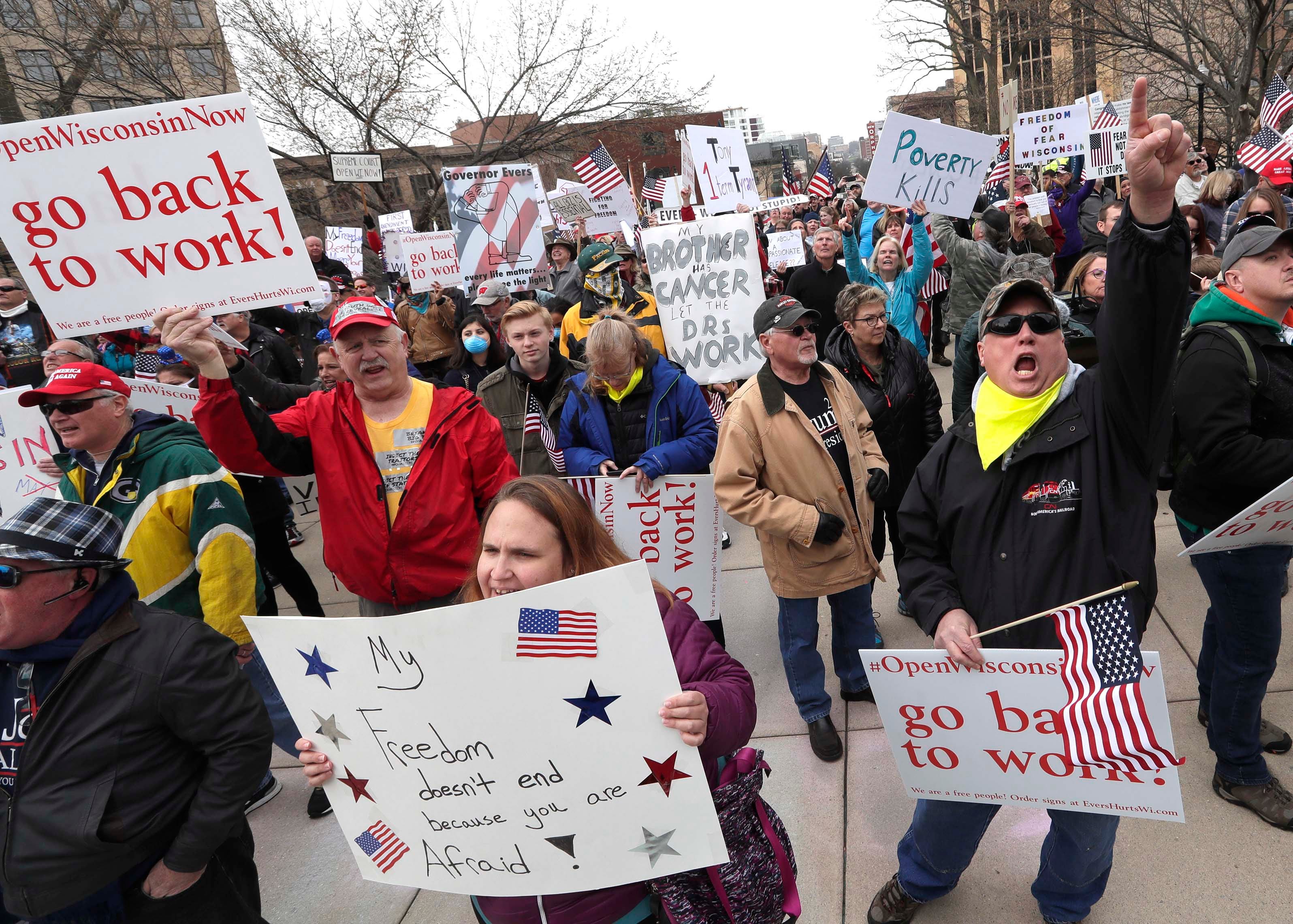 Protesters at the Wisconsin Capitol on April 24 call for the state to reopen, saying a stay-at-home order that closed schools, churches and non-essential businesses to prevent the spread of the coronavirus was causing economic damage.