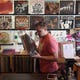 Saxon Julin organizes through stacks of vinyl records on Wednesday, Oct. 7, 2020, at Wax Records, a shop he co-owns with his father, in Vero Beach. The shop, which has been open for six years, saw a decrease in foot traffic when the COVID-19 pandemic began, but a boost in online sales.
