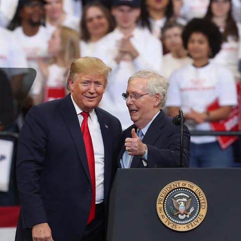 President Donald Trump, left, brought Sen. Mitch M