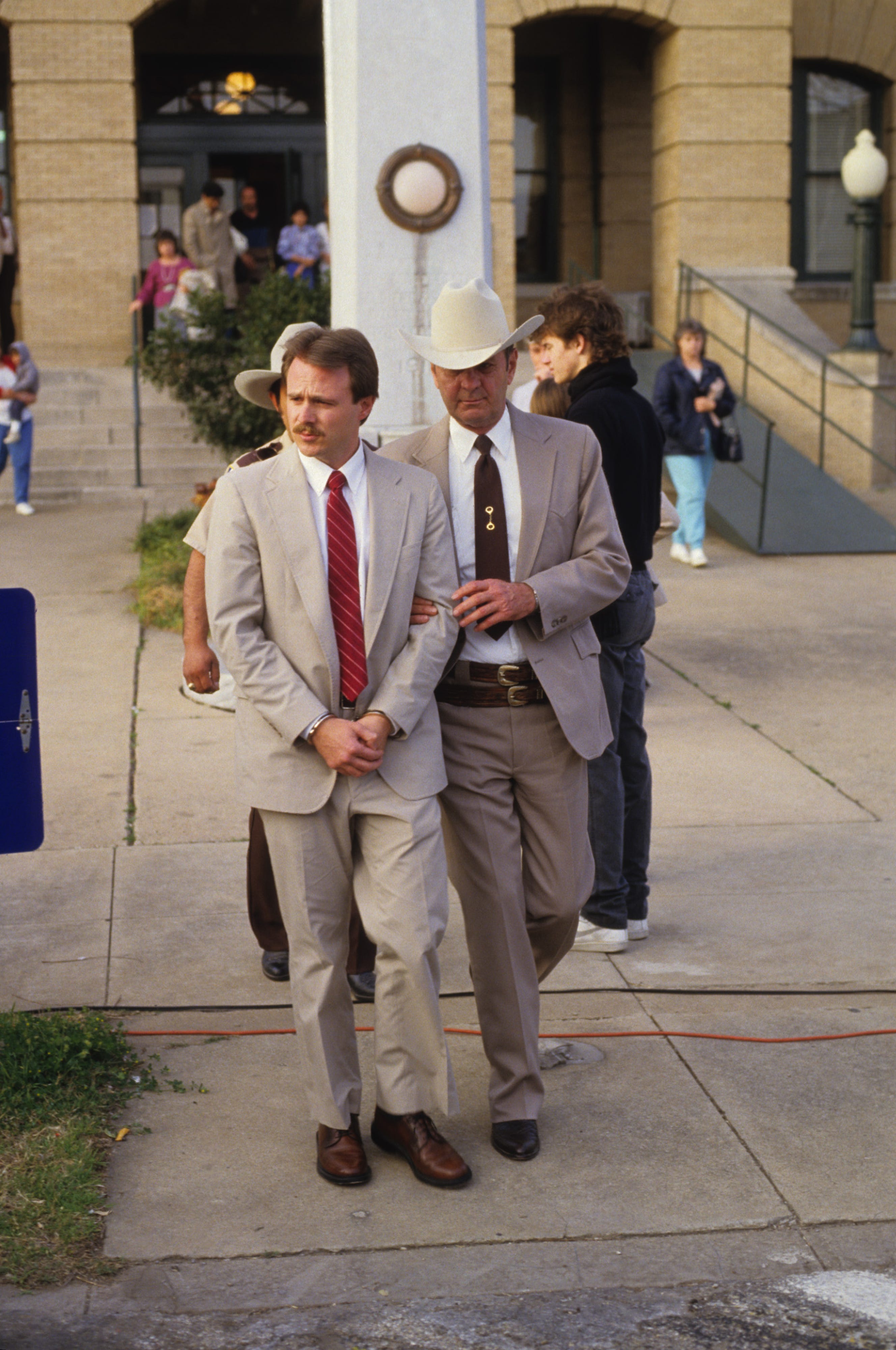 Michael Morton is led from Williamson County Courthouse by Williamson County Sheriff Jim Boutwell after he was sentenced for murdering his wife on Feb. 17, 1987.