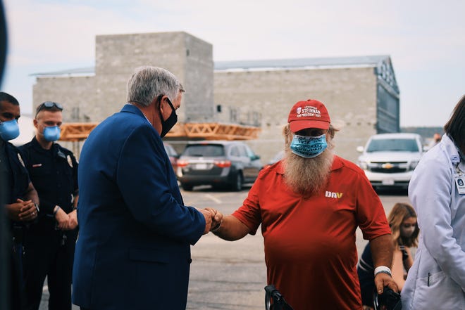 Gov. Mike Parson fist bumps a supporter during an event hosted by the Spirit of Liberty Foundation.