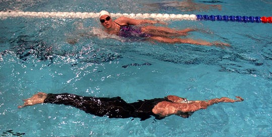 Jenny Thompson, bottom, of Menlo Park, Calif., glides under the surface of the water in a full body FastSkin suit by Speedo as Dara Torres of Palo Alto, Calif. swims in a traditional suit as they practice at the Indiana University Natatorium in Indianapolis Tuesday, Aug. 8, 2000 for the U.S. Olympic Swim Trials. C


MSC103