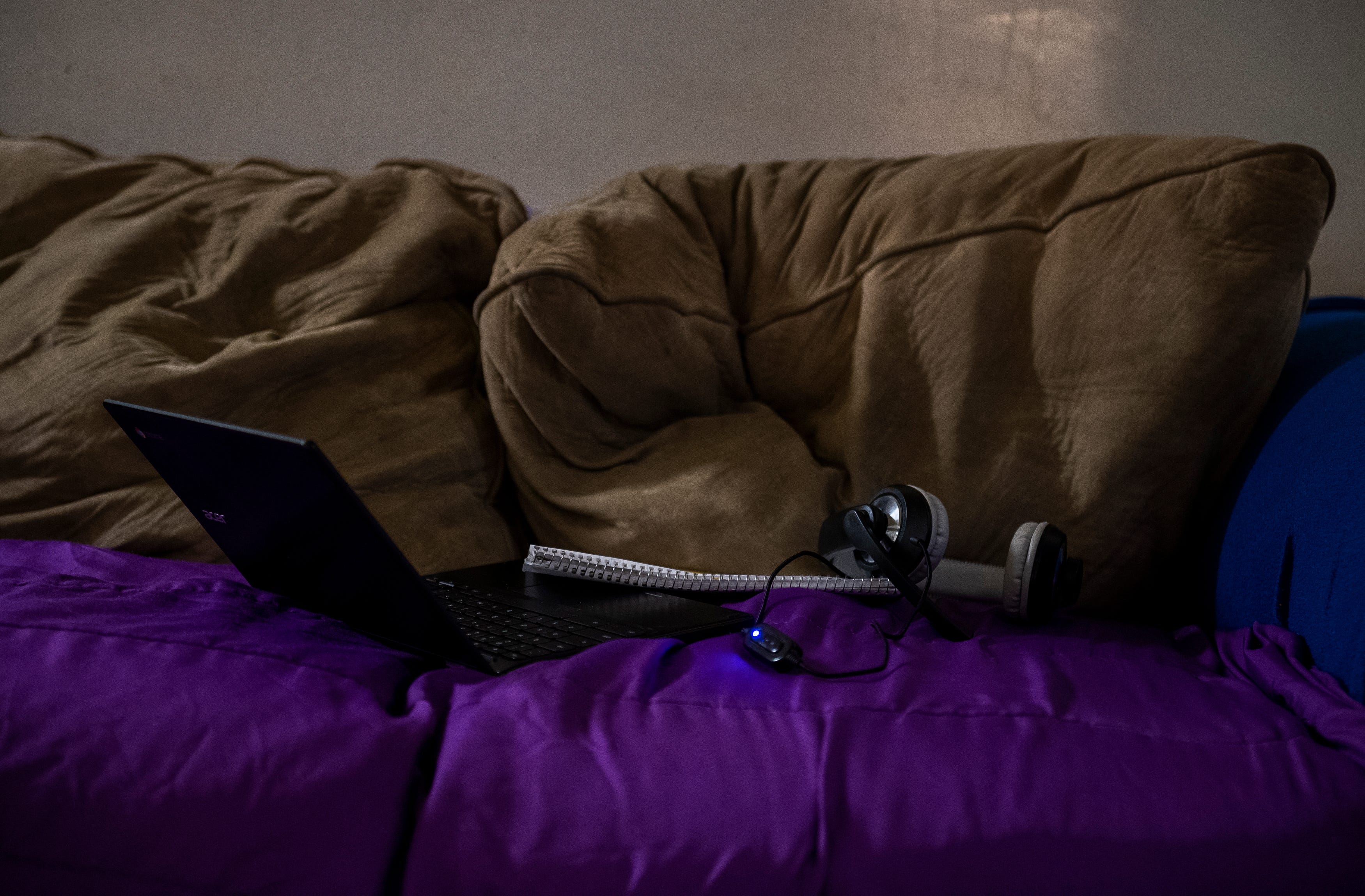 A ChromeBook, notebook and headset sit on a couch as the young girl who was using them takes a small break from her distance learning class in Salinas, Calif., on Thursday, Sept. 17, 2020.