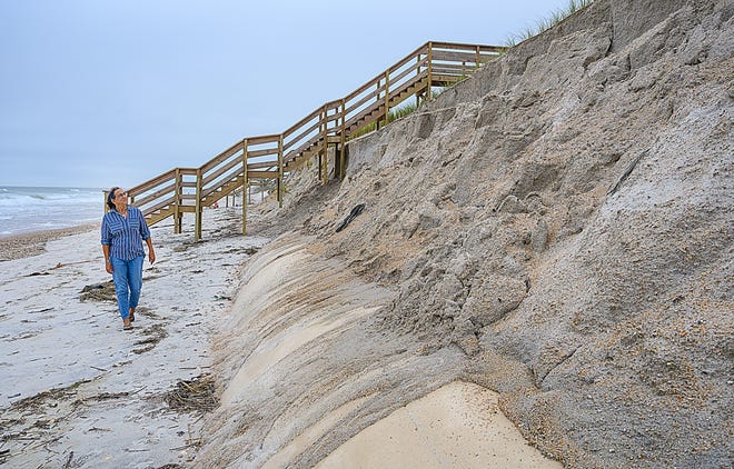 Nicole Crosby walks along a section of Ponte Vedra Beach where erosion from a recent nor'easter has uncovered a section of a geotextile tubes on Wednesday.