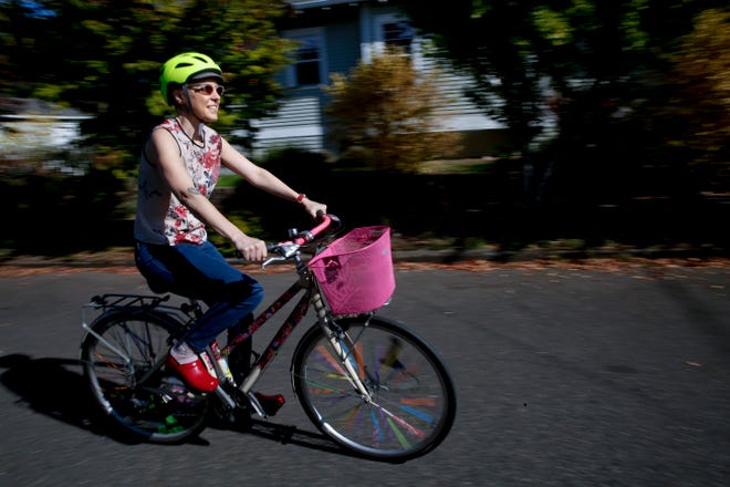 Mara McGraw takes a bike ride in her Portland neighborhood. McGraw's intent during her psilocybin therapy was to "figure out how to keep living when I'm dying."