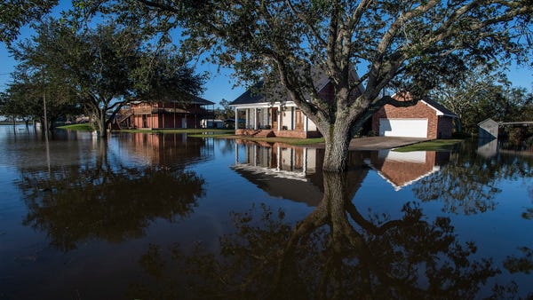 Flood waters surround houses in Delcambre, La., on