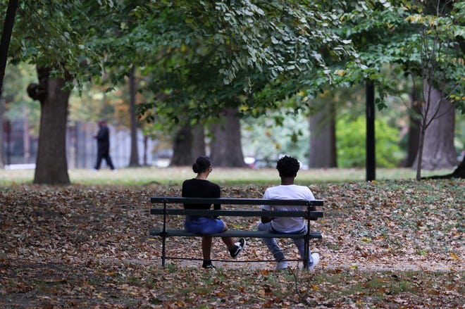 Melanie Hughes, left, and D. Harris met in Central Park in Louisville, Ky. on October 11, 2020 and decided to enjoy the fall afternoon chatting and relaxing on a park bench.