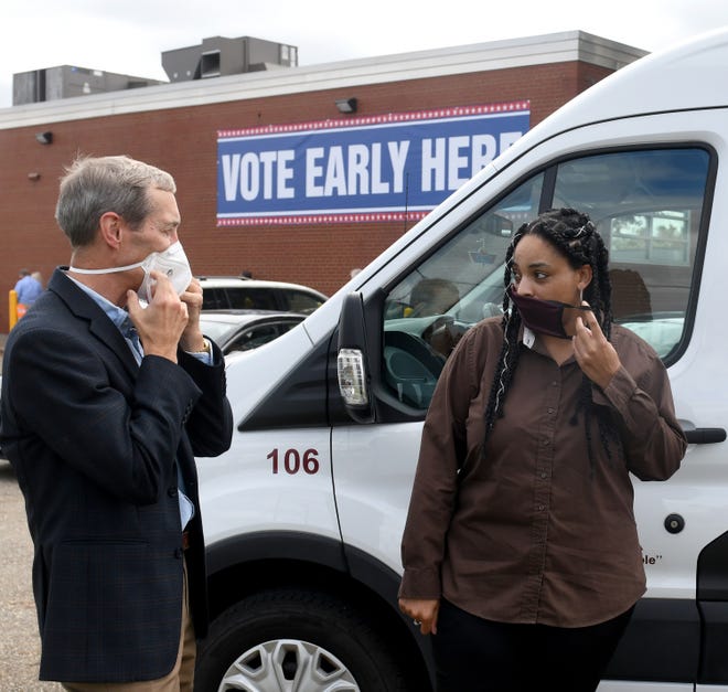 Bob Gessner (left), and Ashley Herring, ABCD's transportation manager, talk about a new Voter Van initiative Monday afternoon outside of the Stark County Board of Elections office in Canton. Gessner and others are sponsoring the free rides to registered county voters who need a lift to the elections board to vote early or cast an absentee ballot.