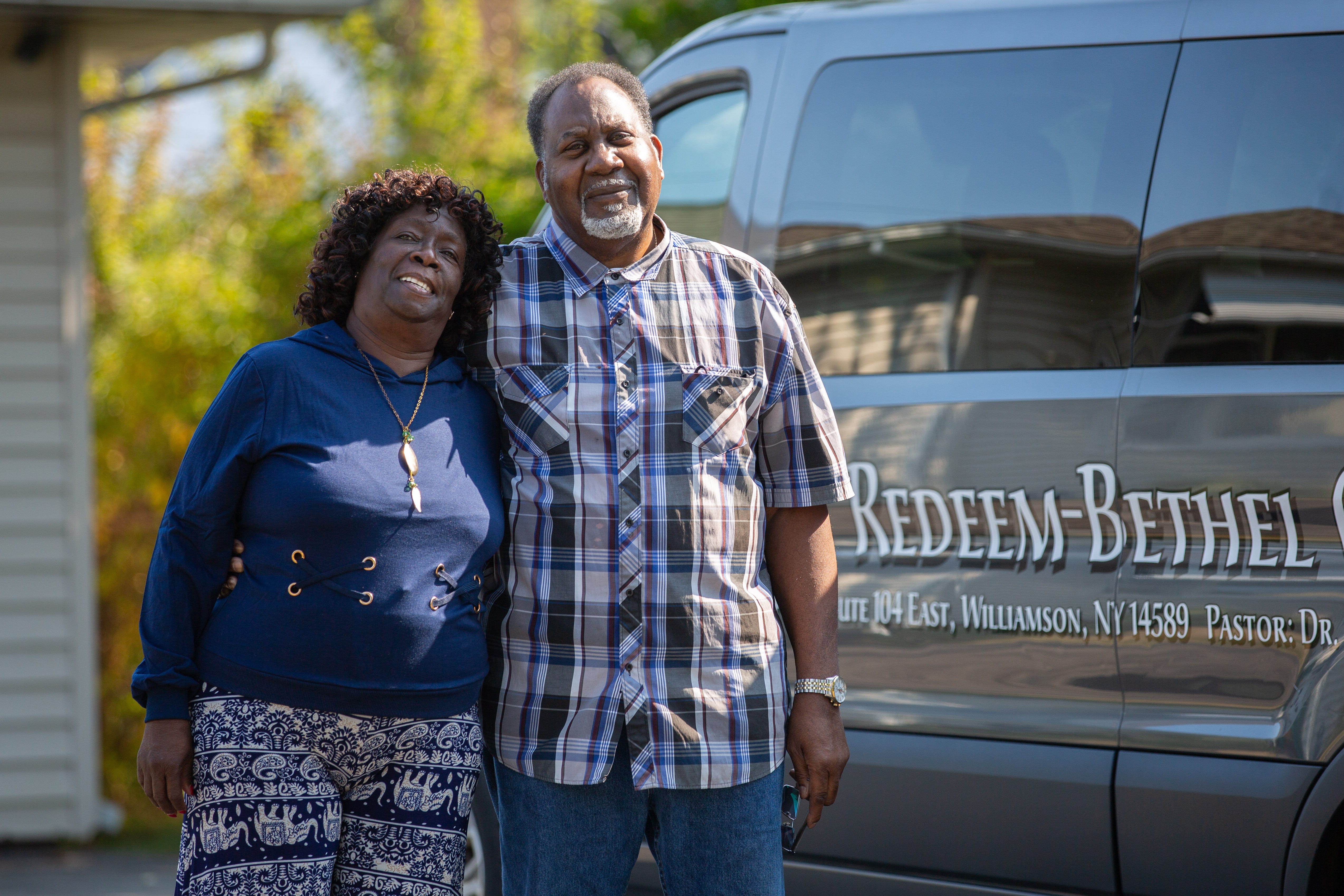 Roberta Carter and her husband, James, stand beside their church's van parked in their driveway.