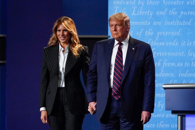 President Donald Trump and first lady Melania Trump hold hands on stage after the first presidential debate at Case Western University and Cleveland Clinic in Cleveland, Ohio, on Sept. 29.
