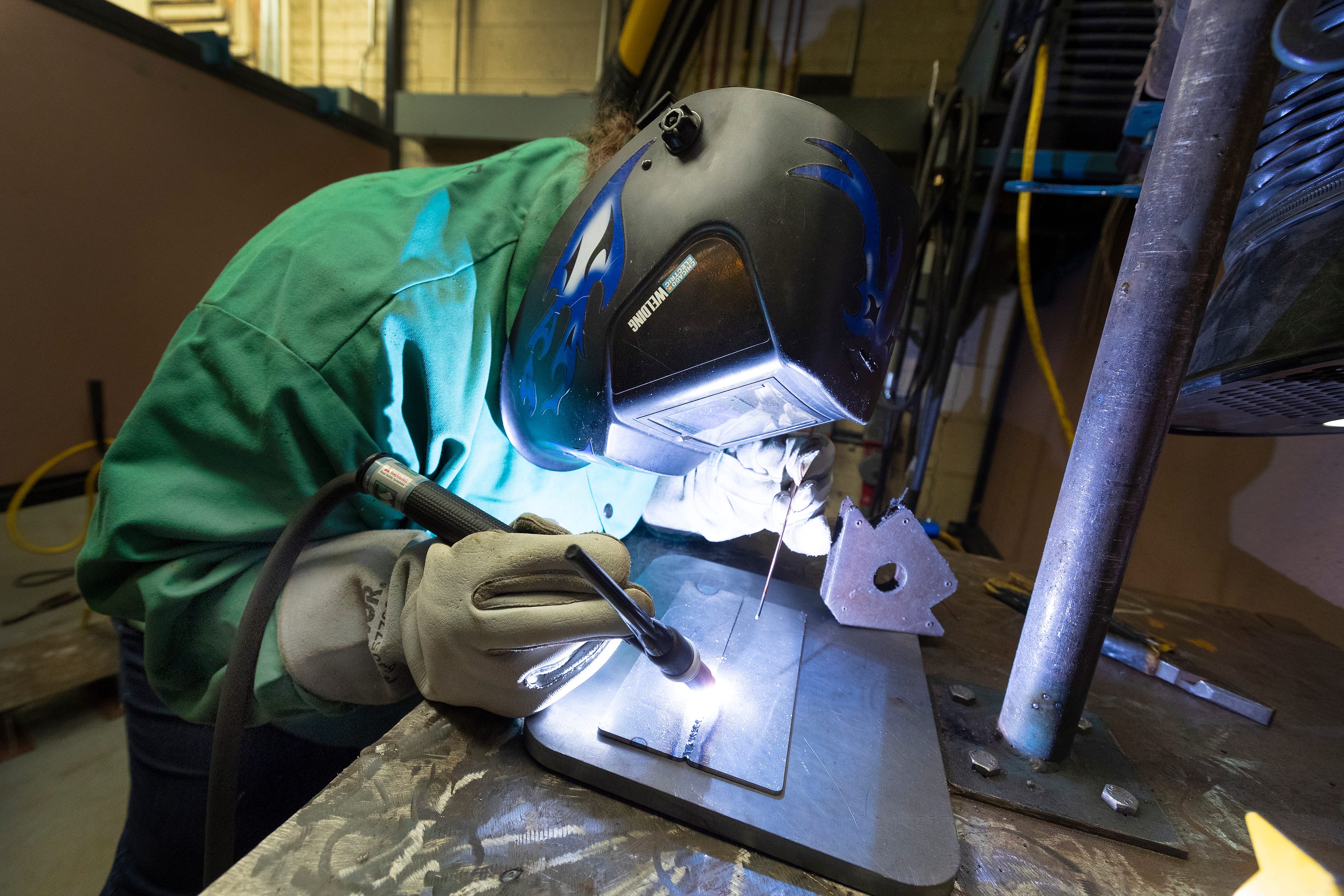 Michelle Moldenauer practices TIG welding at Milwaukee Area Technical College in West Allis on Oct. 13. Moldenauer is going for her associate's degree in welding, but the pandemic has left her uncertain about her plan.