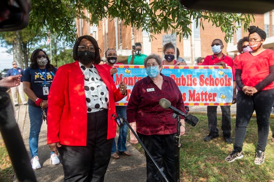 Montgomery Public Schools board Vice President Claudia Mitchell and board President Clare Weil speak during a protest at the MPS central office in Montgomery, Ala., on Tuesday, which was the first day of in-person classes after nine weeks of virtual learning because of the coronavirus.