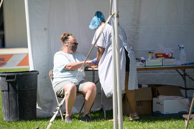 A woman gets tested for the COVID-19 antibody earlier this year at Venetian Gardens in Leesburg. [Cindy Peterson/Correspondent]