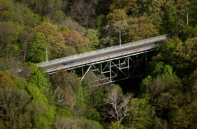 Trees frame Cascade Bridge May 8, 2013, in Burlington. The bridge since has closed to vehicle and foot traffic, but the Burlington City Council on Tuesday officially named the bridge as one of its top five priorities over the next two years.