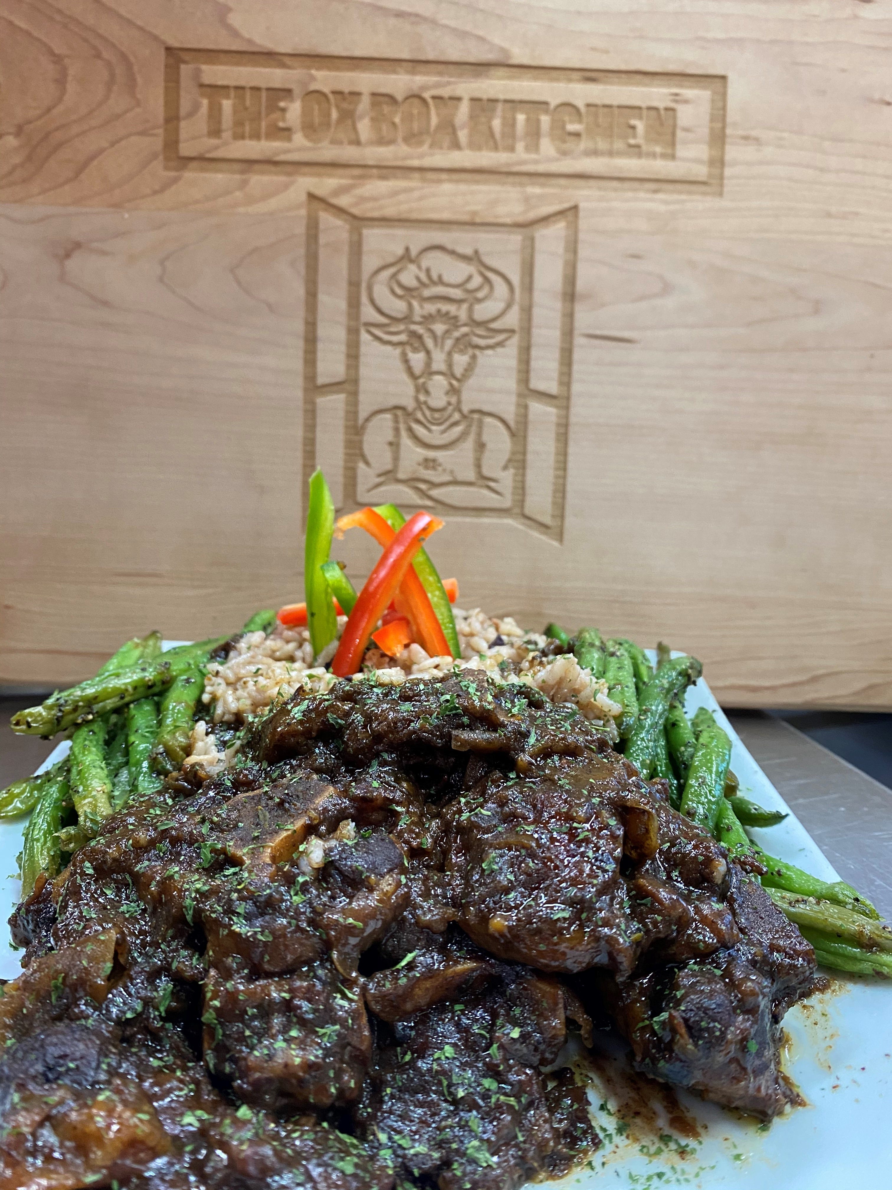 Oxtails served with coconut rice and peas and haricots verts at The OX Box Kitchen in Mount Vernon.