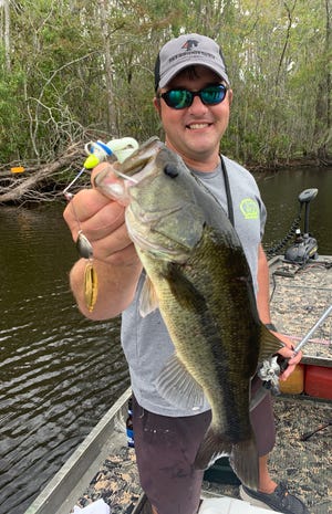 Local angler Andy Bean shows off a bass he caught in Bayou Black during a recent fishing trip.