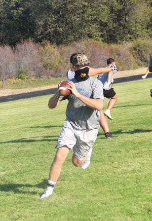 Cole Kindley looks to throw a pass in 2020 during a practice at Joe Blevins Memorial Stadium in Mount Shasta.