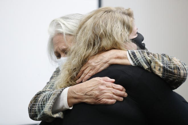 Attorney Fran Watson embraces Kristine Bunch after the conclusion of an Indiana Criminal Justice Institute board of trustees meeting at the Indiana State Government Center South in Indianapolis on Thursday, Oct. 15, 2020. Bunch was exonerated in 2012 and released after spending 17 years in prison for a wrongful conviction in the arson death of her 3-year-old son.
