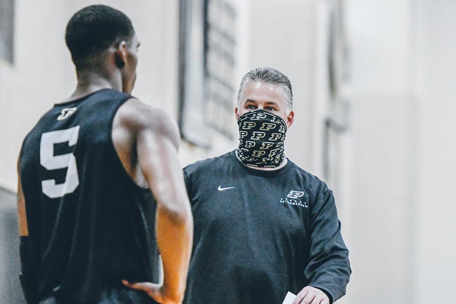 Purdue basketball coach Matt Painter talks to Brandon Newman during Thursday's first practice