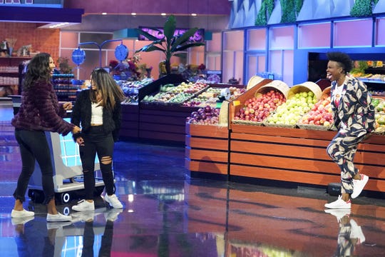Host Leslie Jones, right, is having a good time as she engages with contestants on ABC's revival of "Supermarket Sweep."