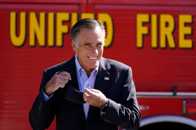 Sen. Mitt Romney, R-Utah, looks on during a news conference Thursday near Neffs Canyon in Salt Lake City. Romney announced legislation to establish a national wildfire commission that would make policy recommendations aimed at diminishing future wildfire disasters.