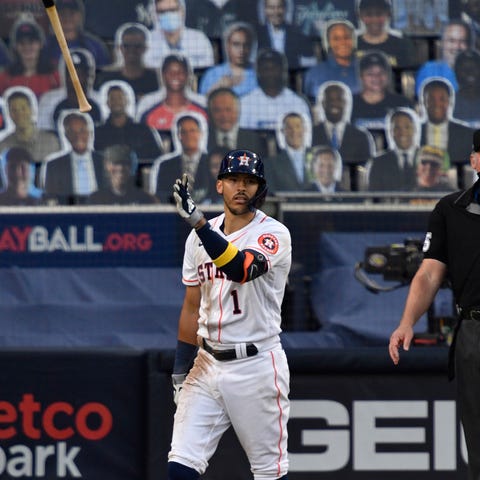 Carlos Correa flips his bat after his walk-off hom