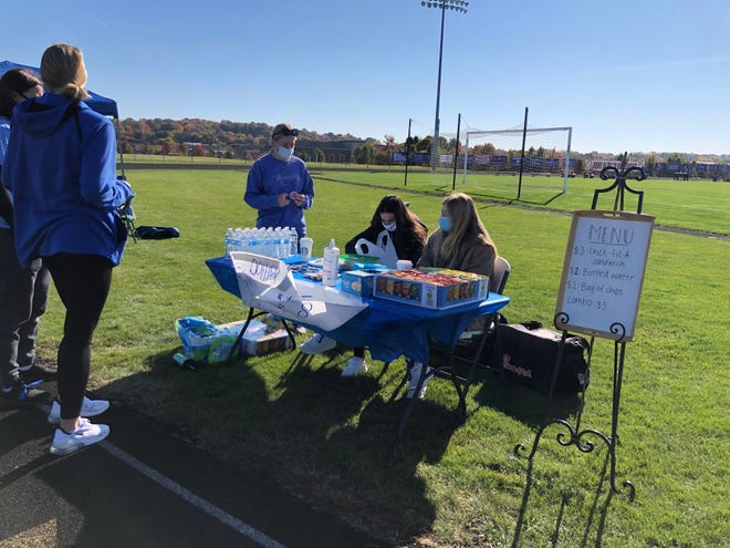 Jackson High School students at the school in Jackson Township Saturday morning sell donated Chick-fil-A sandwiches for $3 to raise money to donate to Rahab Ministries, which is devoted to providing shelter and support to victims of human trafficking. The fundraiser was part of the event Walking in Blue where participants walked a mile on the school's track against human trafficking.