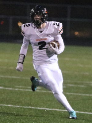 Cedarburg wide receiver Drew Biber takes the ball around the edge against West Bend East on October 16, 2020.