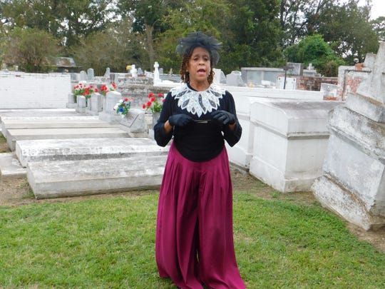 Sheryl Ned portrays Madame Baldwin, an Opelousas business owner and free woman of color from the city's history, during the 18th annual St. Landry Church Cemetery tour, which concluded Sunday. During the event, groups are guided among the gravesites in the St. Landry Catholic Church cemetery  where they were met by reenactors portraying former prominent residents who helped to shape St. Landry Parish history.