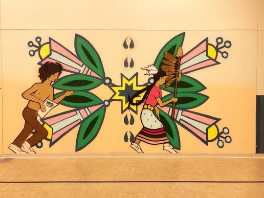 A mural features running Native American youths, one of them carrying a paper urging the viewer to vote. The mural, painted by artist Jeremy Fields, is one of many painted by Fields urging tribal members across the nation to engage on Election Day. This mural is located on the Standing Rock Indian Reservation in Wakpala, S.D.
