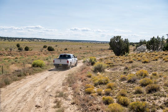 One of the trucks used to deliver supplies to at-risk residents drives down a long dirt driveway on the Ramah Navajo Indian Reservation. The pandemic has caused many Native Americans, particularly elders who have been passionate about voting in person throughout their lives, to stay indoors, which activists fear will depress voter turnout.