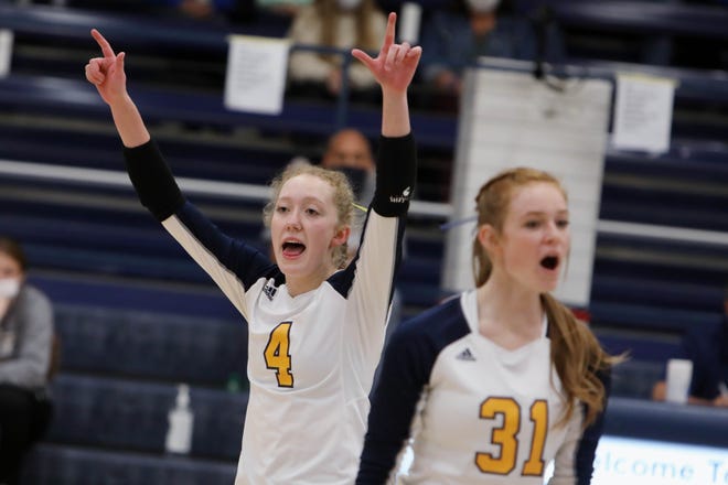 Notre Dame High School's Josie Bentz (4) celebrates a point along with teammate Abby Kroshgen (31) during their Class 1A Region 8 game against Wapello High School Monday at Notre Dame's Father Minett Gymnasium.