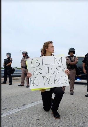 Alexander Savage, shown at a June 6 demonstration on Southern Boulevard, was arrested at a Sunday, May 31, 2020, demonstration in downtown West Palm Beach, one of numerous protests following the death of George Floyd. [Supplied]