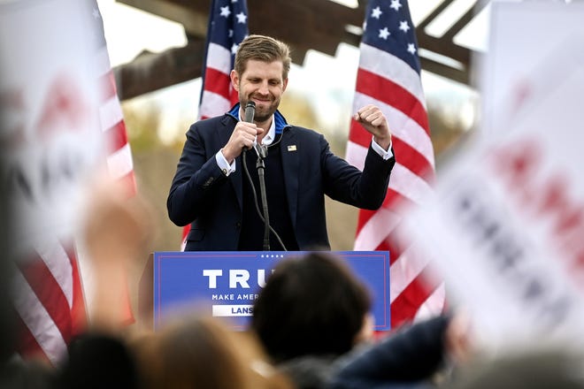 Eric Trump pumps his fist to the chants of the crowd after speaking on Tuesday, Oct. 20, 2020, at Schlegel Sand and Gravel in Lansing.