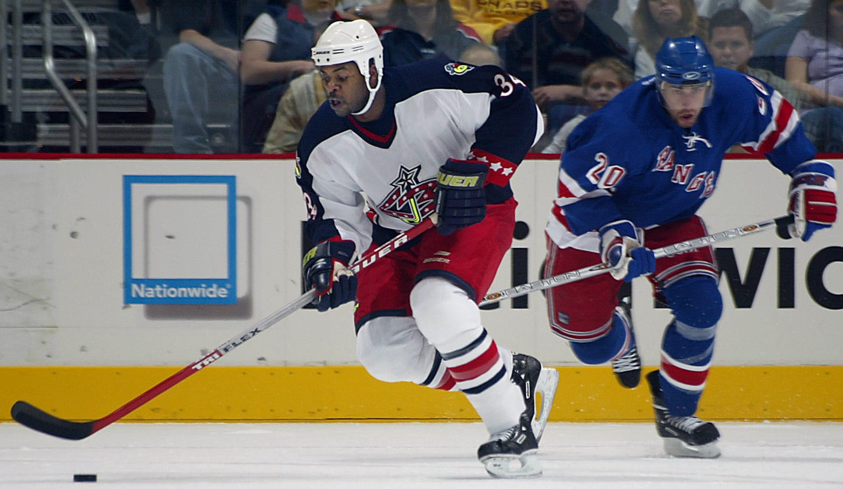 Jean-Luc Grand-Pierre, left, playing in a game against the New York Rangers at Nationwide Arena in 2002