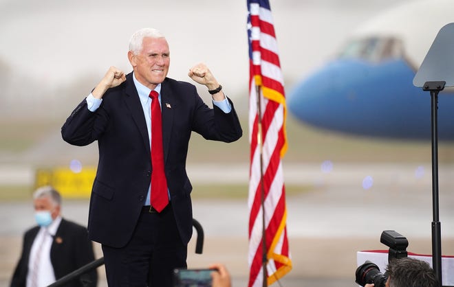 Vice President Mike Pence arrives on stage to greet a crowd at Port City Air at the Portsmouth International Airport at Pease on Wednesday.