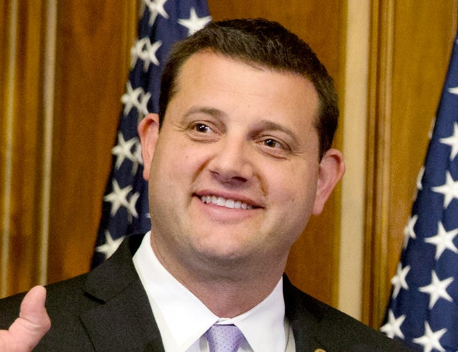 In this Jan. 6, 2015, file photo, Rep. David Valadao, R-Calif., poses during a ceremonial re-enactment of his swearing-in ceremony in the Rayburn Room on Capitol Hill in Washington. He is challenging Democrat T.J. Cox, who defeated him for his seat in 2018. California's tarnished Republican Party is hoping to rebound in a handful of U.S. House races but its candidates must overcome widespread loathing for President Donald Trump and voting trends that have made the nationâ€™s most populous state an exemplar of Democratic strength. (AP Photo/Jacquelyn Martin, File)