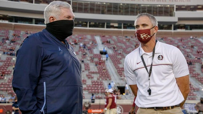 North Carolina coach Mack Brown, left, visits with Florida State coach Mike Norvell before the start of last weekend’s game won by the Seminoles.