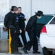 Amish brothers Aaron C.M. Schwartz and Petie C.M. Schwartz are loaded into the back of a police car outside the Webster County Courthouse after their probation was revoked on Thursday, Oct. 22, 2020 and they were sent to prison for 15 years.