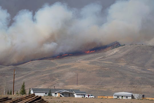 Smoke rises from mountain ridges as a wildfire burns Thursday, Oct. 22, near Granby, Colorado.